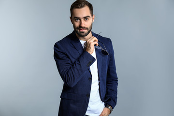 Handsome fashionable man on grey background