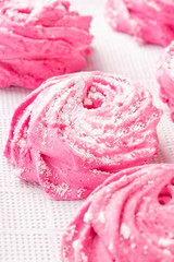 Homemade pink marshmallow on a white kitchen napkin close-up.
