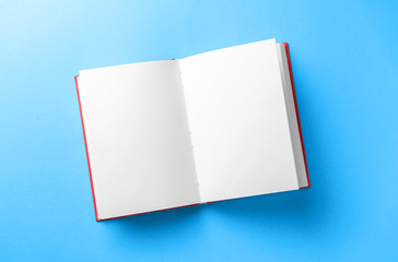 Open book on color background
