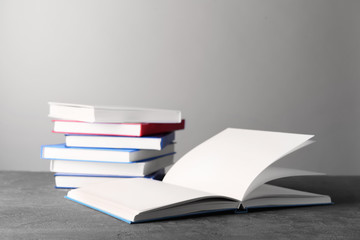 Many books on table against grey background