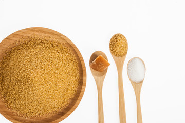 white sugar, brown sugar and sugar cane panela on white background