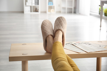 Young woman in slippers resting at home
