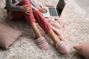 Young woman in slippers at home