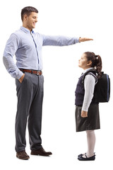 Young man in formal clotes gesturing with hand and showing the height of a little schoolgirl