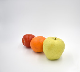 Tomato, orange, apple on the white background