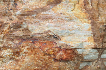 Textured of surface stone wall for background. Tone orange, brown and red color same rust.