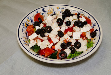 Greek salad with fresh vegetables, feta cheese and black olives