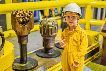 Boy operator recording operation of oil and gas process at oil and rig plant, offshore oil and gas...
