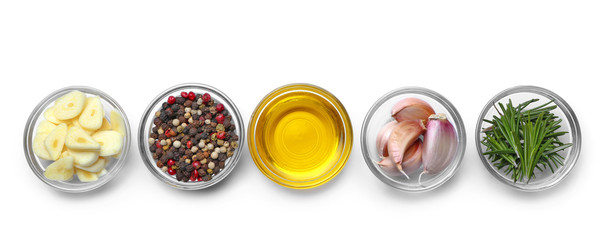 Bowls with fresh garlic and spices on white background