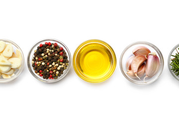 Bowls with fresh garlic and spices on white background