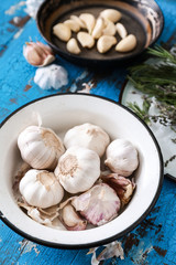 Bowl with fresh garlic on wooden background