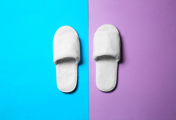 Soft slippers on color background