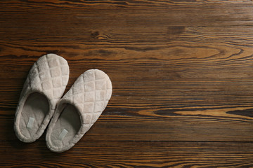 Soft slippers on wooden background