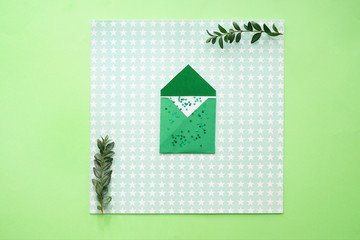 Composition with green envelope on color background
