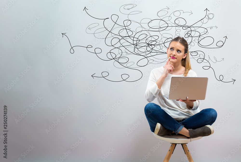 Wall mural solving a problem concept with young woman using her laptop on a grey background