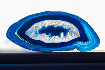Translucent agate cut on the stand with white backround
