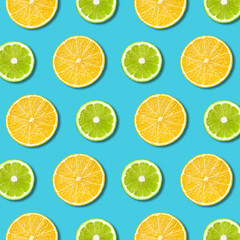 Vibrant lemon and green lime slices pattern on turquoise color background. Minimal flat lay top view food texture 