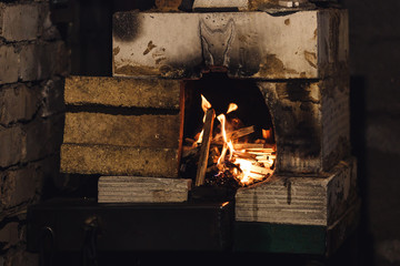 close up photo of homemade forge furnace with flame.