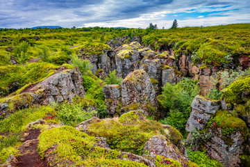 Panoramic view of lava field near lake Myvatn, town Reykjahlid, and volcanoes Hverfjall and Krafla on Iceland, summer time