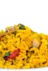 Paella served on a plate surrounded by blurred background