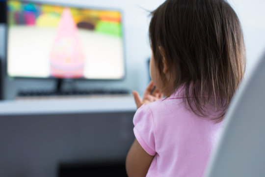 Young child watching tv on the computer at home