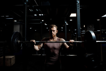 Strong man posing in gym