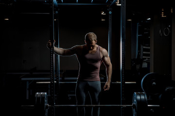 Fototapeta na wymiar Strong man posing in gym