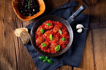 Baked mini meatballs in tomato sauce with basil