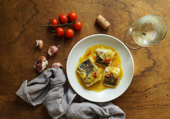 bacalao al pil pil, salted cod in emulsified olive oil sauce, spanish cuisine, basque country     