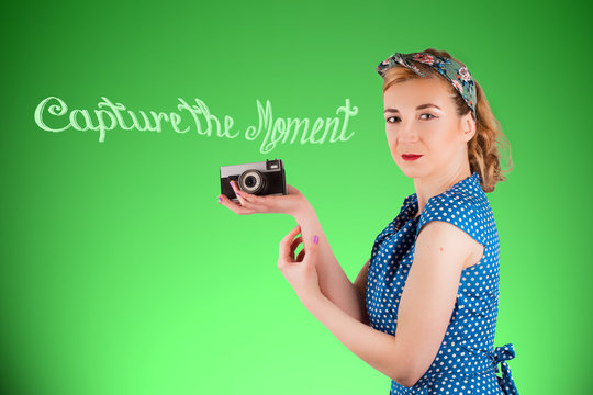 Young woman holding a vintage camera in her hand