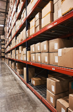 Cardboard boxes on shelves in warehouse