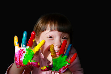 Cute little kid with painted hands isolated on the black