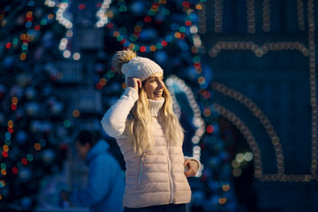 Young woman with skates on the ice rink