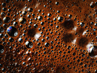 Macro shot of coffee foam. Coffee crema close-up.