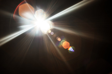 Lens Flare. Light over black background. Easy to add overlay or screen filter over photos. Abstract...