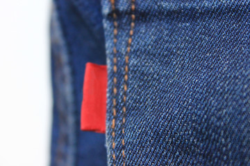 Denim Jeans with Empty Red Label Close Up Top View, Selective Focus. Casual Vintage Style Casual...