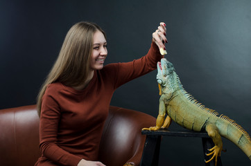 sensual woman and green iguana in studio