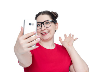 Funny happy young woman in glasses with smartphone make selfie, isolated on white background.