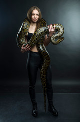 sexy woman and python in studio