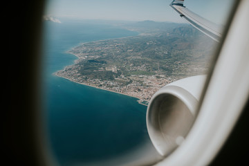 Airplane engine and wing, and Costa del sol sea shore viewed from a plane through the plane window, before landing. - 250291935
