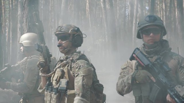 American soldiers patrol the perimeter in the forest
