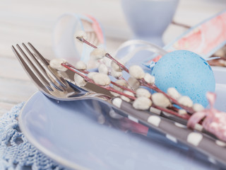Easter table setting with willow branches and cutlery