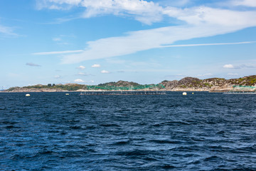 Fototapeta na wymiar Norwegian coast with aquaculture farm