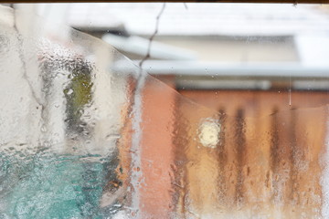 frosty pattern on glass winter window, look through glass 