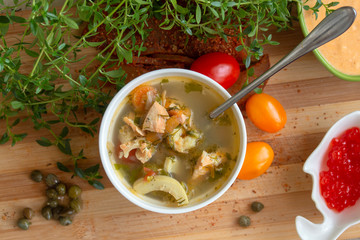 Mediterranean soup with squid, shrimp, salmon, carrots, zucchini, cherry tomatoes, leek, onion, garlic, white wine and green spices.