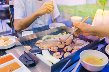 Happiness Enjoy eating Korean BBQ traditional famous food with family in a Korean restaurant