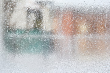 frosty pattern on glass winter window, look through glass 