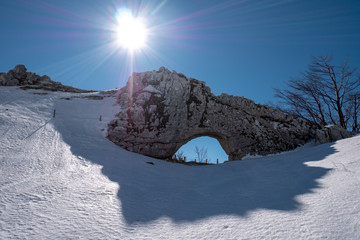 Campo dell'Arco with snow a natural arch on Matese mountain, Campania, Italy