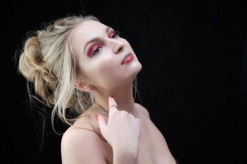 Smiling girl with clean skin, natural make-up and white teeth on a gray background in a beauty salon