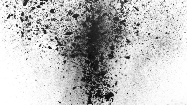 Explosion of black powder on white background
